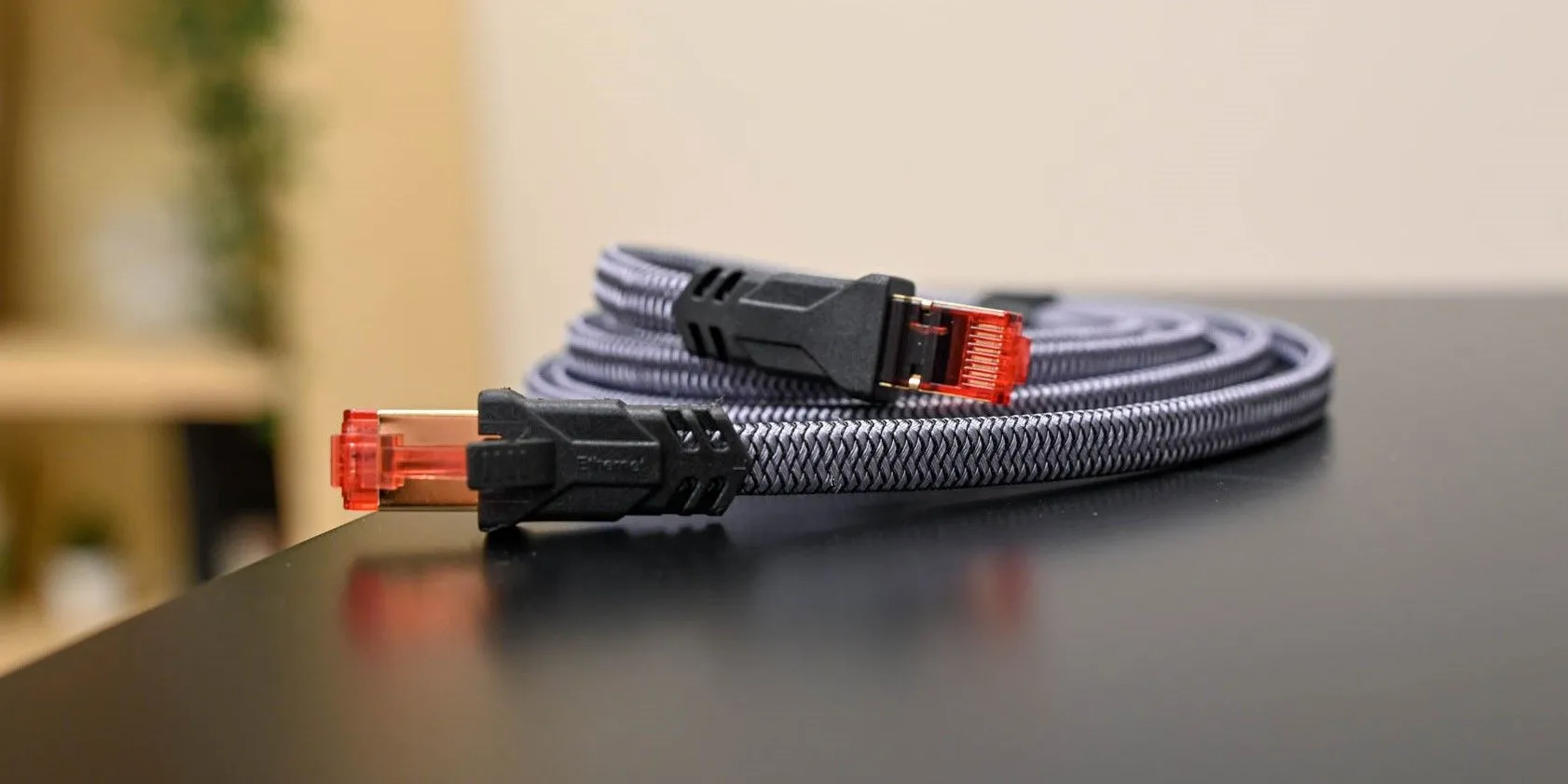 Dây mạng Ethernet Cat 8 cuộn tròn trên bàn với nền mờ