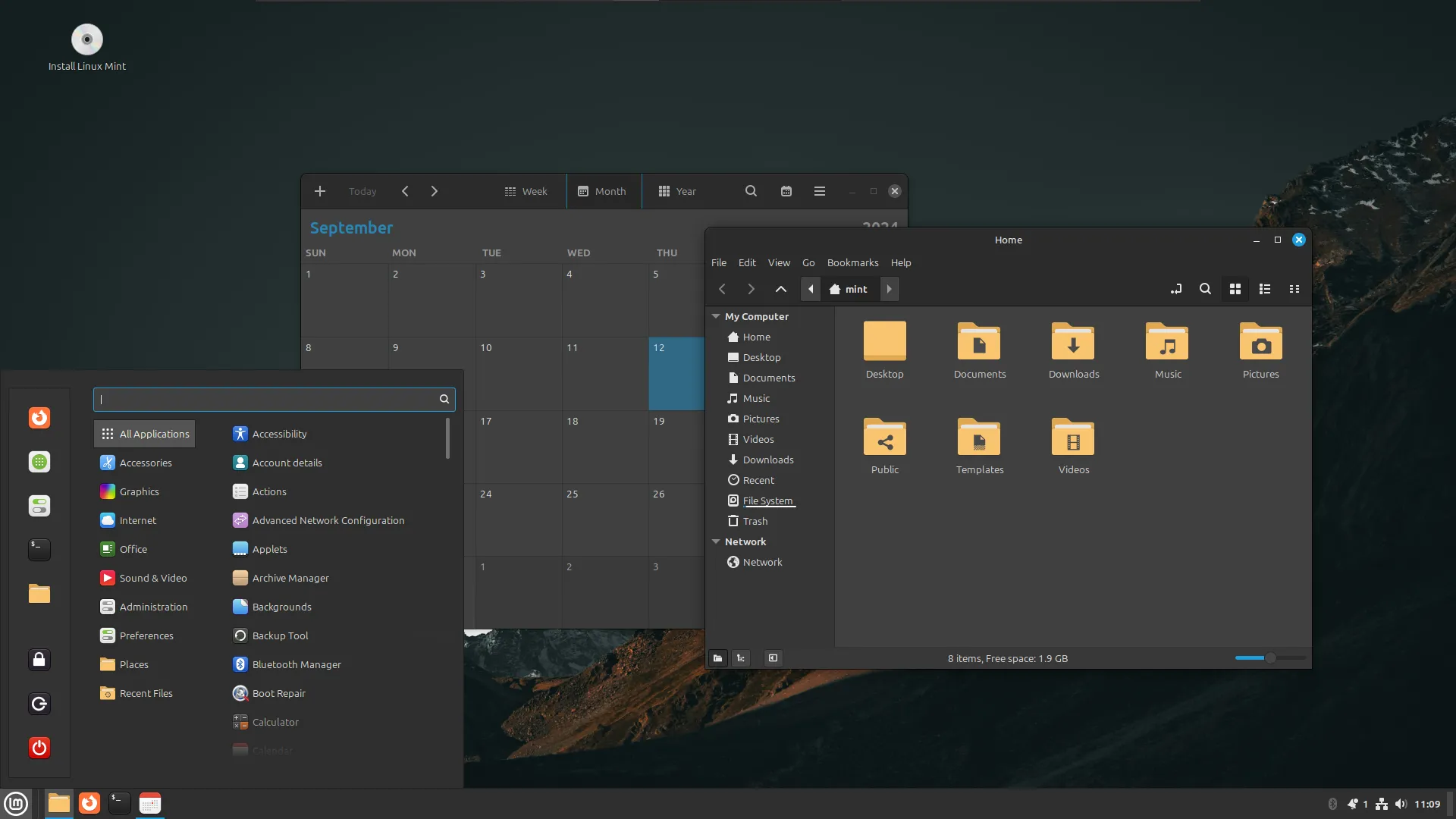 Giao diện màn hình nền Linux Mint với ứng dụng lịch và trình quản lý tệp đang mở, minh họa một hệ điều hành di động hoàn chỉnh trên USB Live Linux.