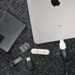 Hình ảnh minh họa các ổ đĩa gắn ngoài và iPad, tượng trưng cho việc quản lý và tổ chức dữ liệu trên các phân vùng khác nhau